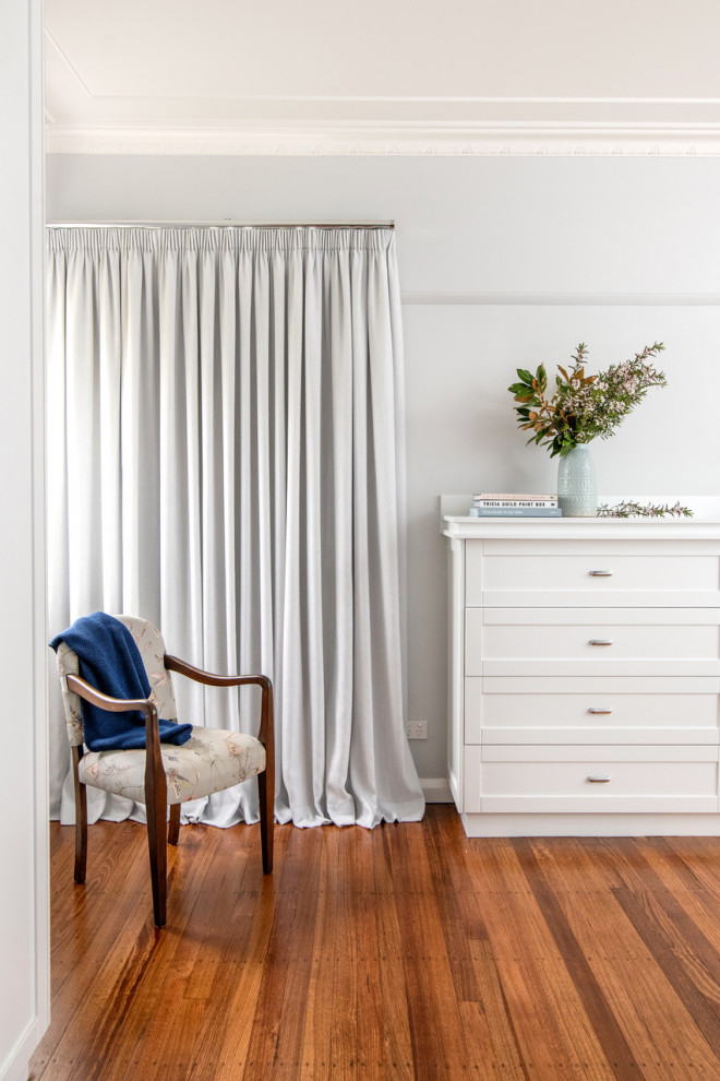 Inspiration for a small traditional master bedroom with white walls and dark hardwood floors.