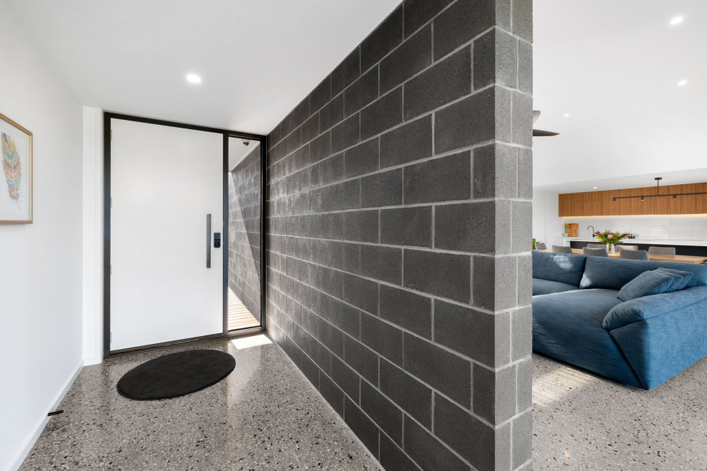 Mid-sized front door in Geelong with concrete floors, a single front door, a white front door and brick walls.