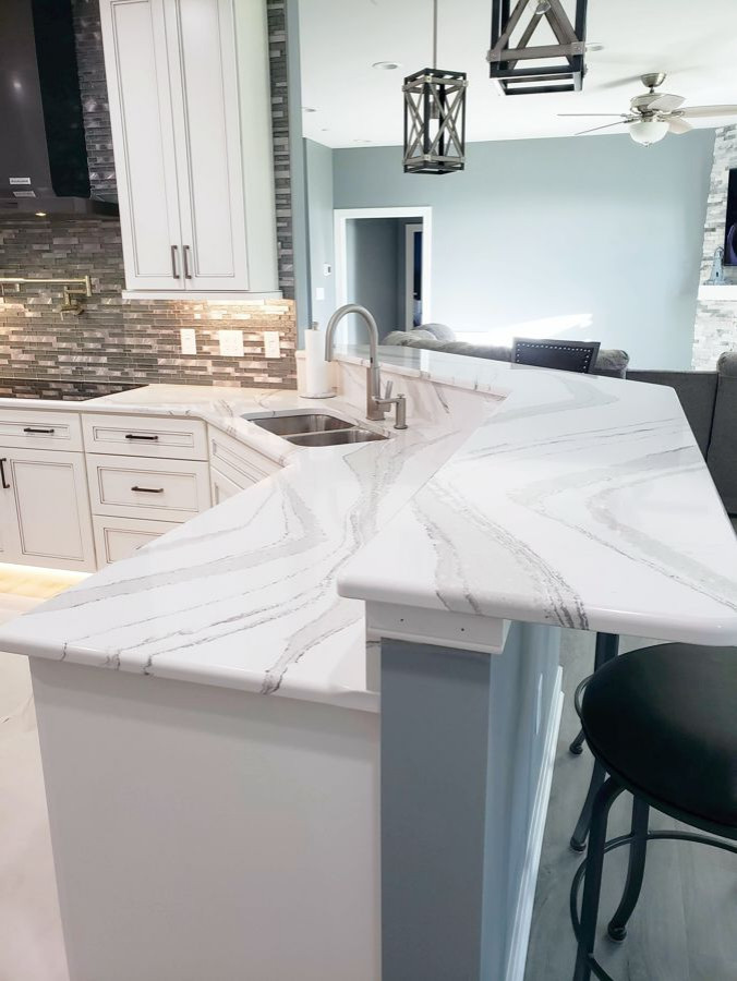 Transitional u-shaped eat-in kitchen photo with recessed-panel cabinets, white cabinets, quartz countertops, multicolored backsplash, mosaic tile backsplash, two islands and white countertops