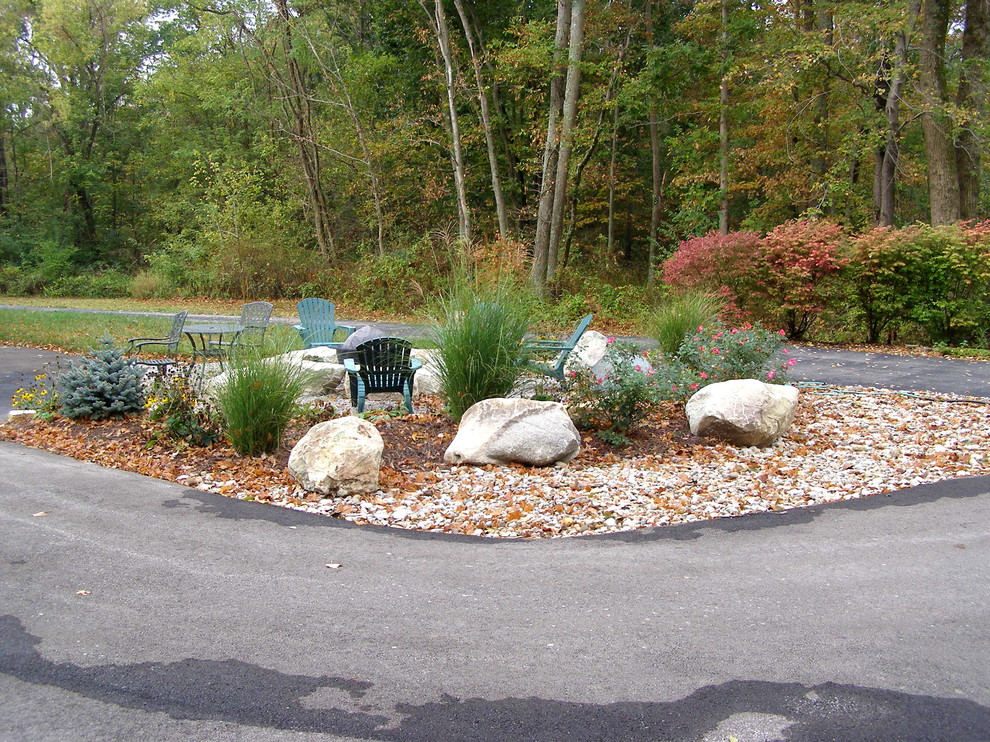 Design ideas for a rustic stone landscaping in Cincinnati with a fire pit.