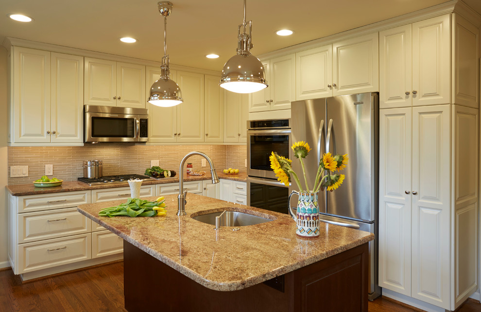 Inspiration for a mid-sized transitional l-shaped dark wood floor eat-in kitchen remodel in Baltimore with an undermount sink, raised-panel cabinets, white cabinets, granite countertops, beige backsplash, glass tile backsplash, stainless steel appliances and an island