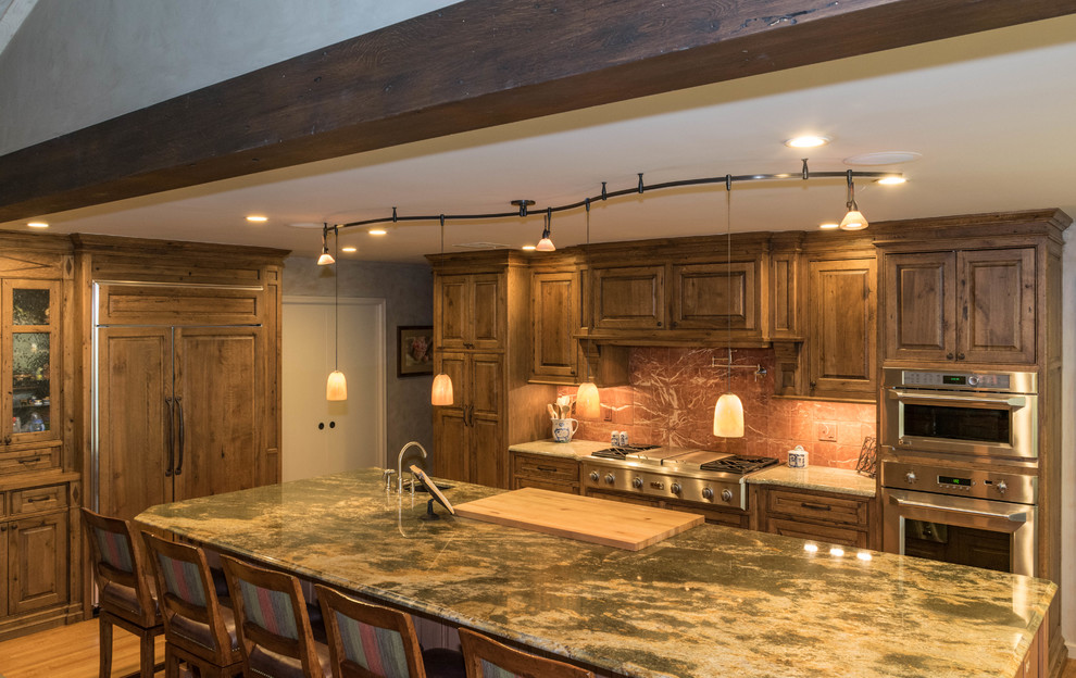 Example of a large mountain style u-shaped eat-in kitchen design with distressed cabinets, granite countertops, stone slab backsplash, stainless steel appliances and an island