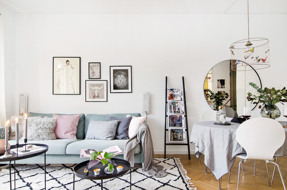 Inspiration for a mid-sized scandinavian formal open concept living room in Stockholm with white walls, light hardwood floors and no tv.