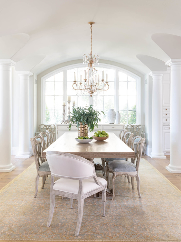 This is an example of a traditional dining room in Orange County with grey walls, medium hardwood floors and brown floor.