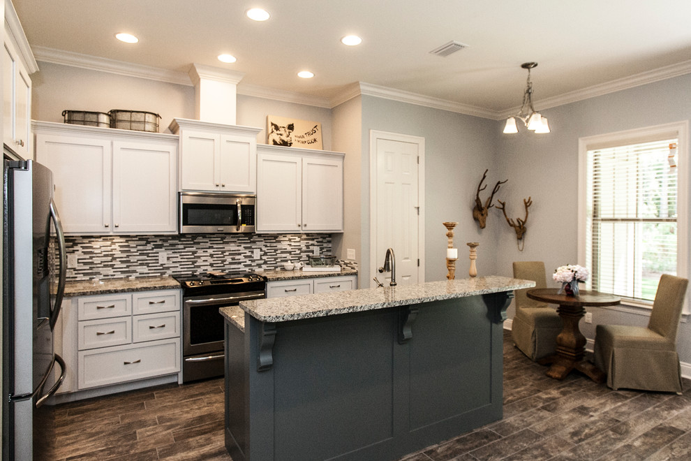 Mid-sized arts and crafts l-shaped eat-in kitchen in Miami with grey cabinets, stainless steel appliances, ceramic floors, with island, a double-bowl sink, shaker cabinets, granite benchtops, grey splashback and mosaic tile splashback.