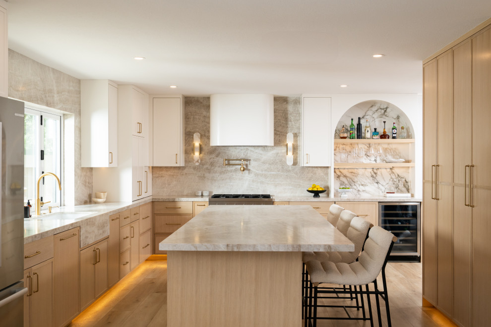 Eat-in kitchen - mid-sized transitional u-shaped light wood floor and beige floor eat-in kitchen idea in Orange County with shaker cabinets, light wood cabinets, quartzite countertops, stone slab backsplash, paneled appliances, an island, an undermount sink, beige backsplash and beige countertops