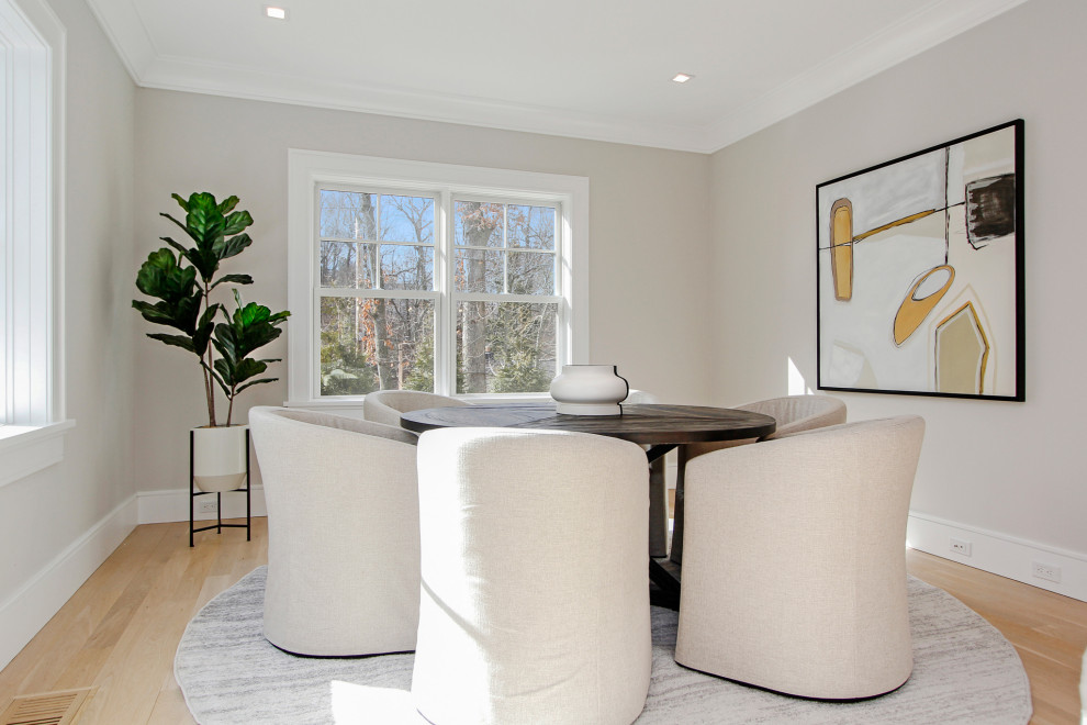 This is an example of a mid-sized contemporary separate dining room in New York with white walls and light hardwood floors.