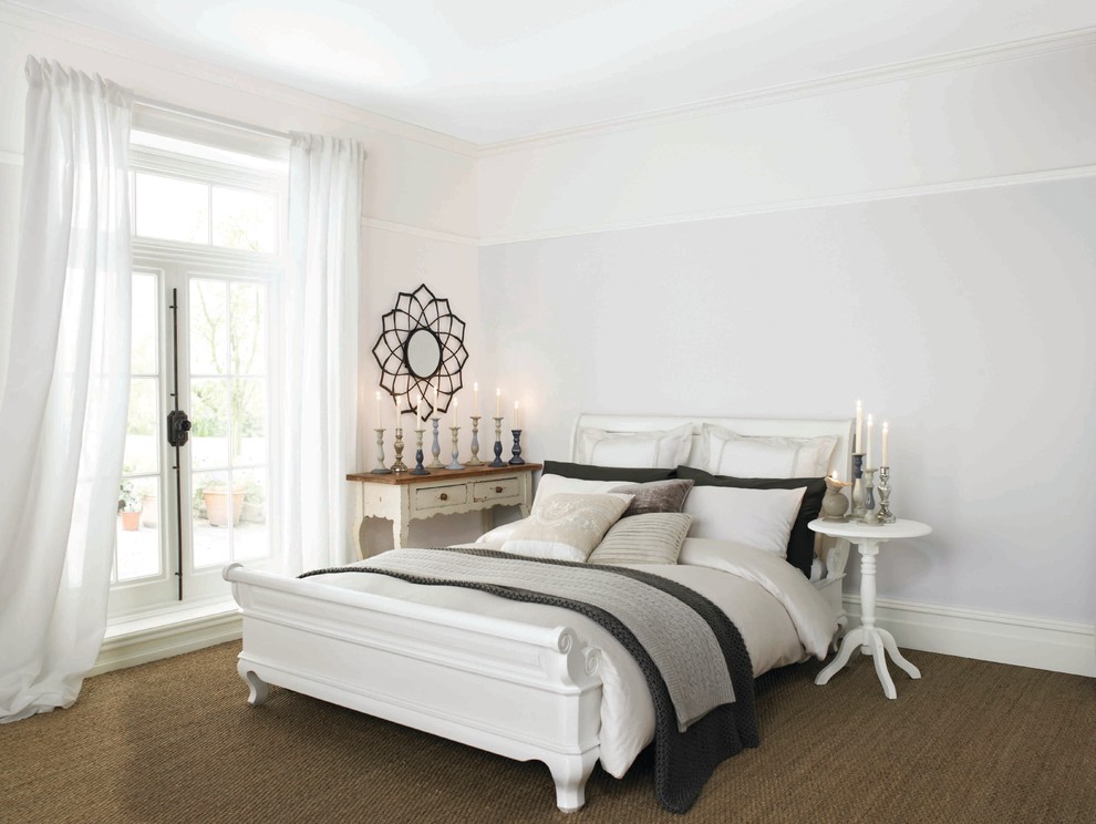 Inspiration for a large beach style guest bedroom in Dublin with white walls and carpet.