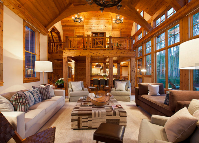 Example of a large mountain style formal and open concept medium tone wood floor and brown floor living room design in Denver with beige walls, no fireplace and no tv