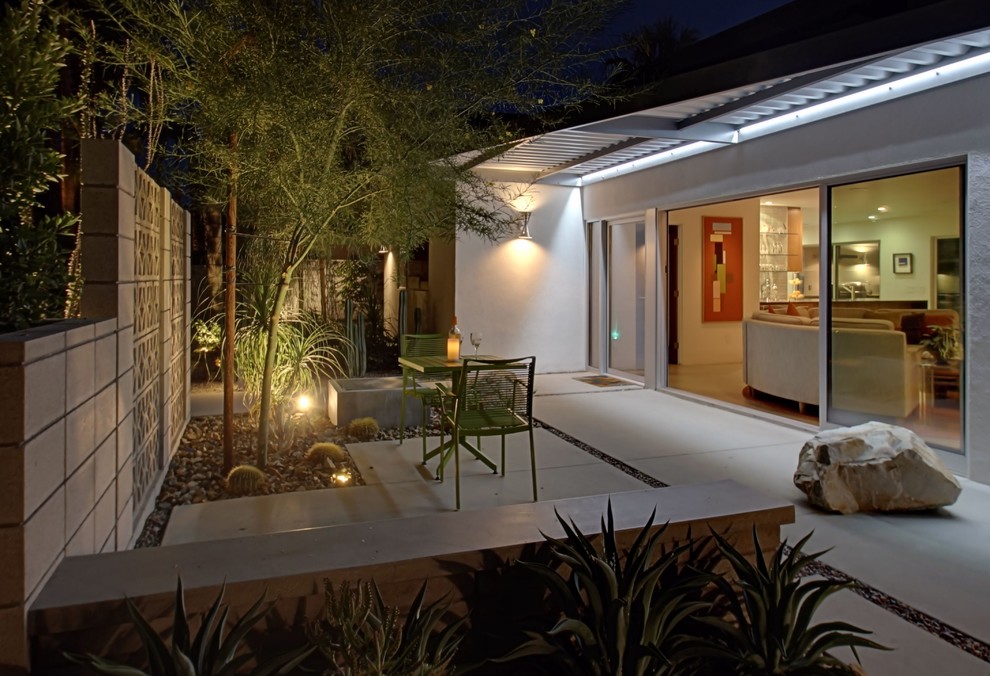 Mid-sized midcentury side yard verandah in Other with an awning and concrete slab.