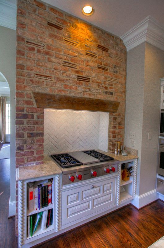 Eat-in kitchen - mid-sized transitional l-shaped medium tone wood floor eat-in kitchen idea in Charlotte with an island, an undermount sink, raised-panel cabinets, white cabinets, marble countertops, multicolored backsplash, stone slab backsplash and stainless steel appliances