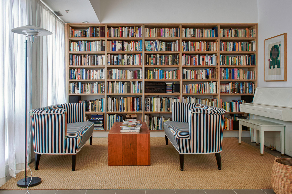 Design ideas for a contemporary family room in DC Metro with a library, white walls and no tv.