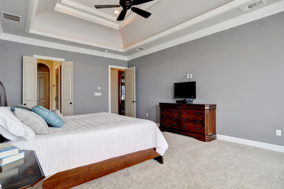 Inspiration for a large transitional master bedroom in Dallas with grey walls and carpet.