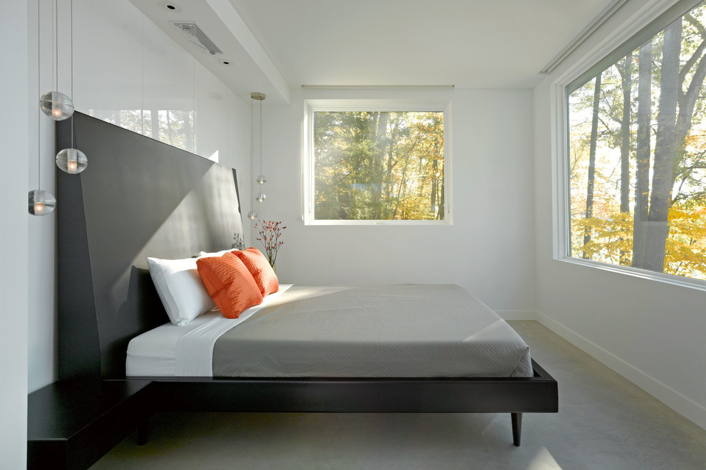Design ideas for a contemporary bedroom in Burlington with concrete floors.