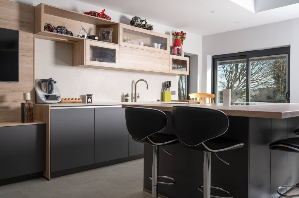 Photo of a large modern single-wall home bar in Hertfordshire with flat-panel cabinets, grey cabinets and concrete benchtops.