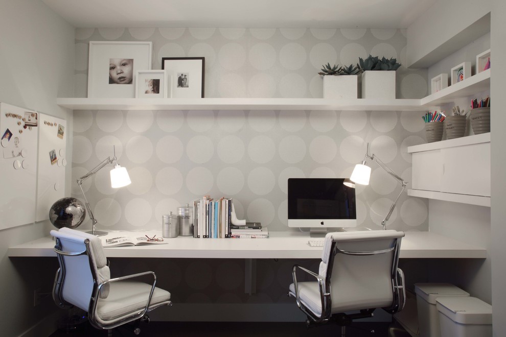 This is an example of a contemporary home office in Vancouver with grey walls and a built-in desk.