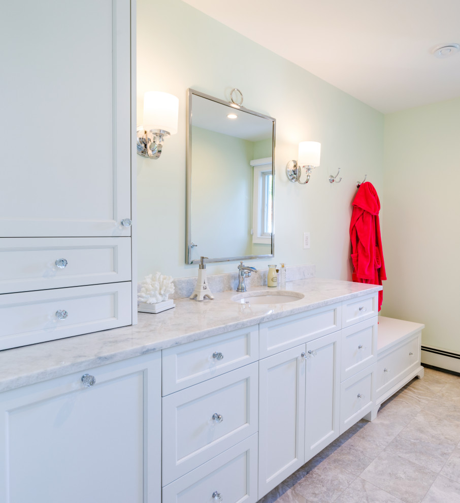Photo of a mid-sized transitional kids bathroom in Philadelphia with shaker cabinets, white cabinets, an alcove shower, a two-piece toilet, white tile, subway tile, white walls, ceramic floors, an undermount sink, marble benchtops, beige floor, a hinged shower door, beige benchtops, a shower seat, a single vanity and a freestanding vanity.