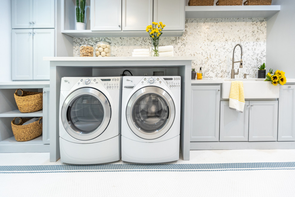 Inspiration for a contemporary laundry room in Tampa with a farmhouse sink, shaker cabinets, blue cabinets, quartzite benchtops, multi-coloured splashback, marble splashback, blue walls, porcelain floors and white floor.