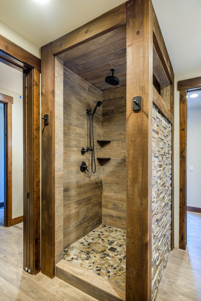 Design ideas for a mid-sized country 3/4 bathroom in Denver with shaker cabinets, dark wood cabinets, a corner shower, a two-piece toilet, beige walls, porcelain floors, granite benchtops, brown tile, multi-coloured tile and stone tile.