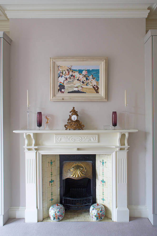 Design ideas for a traditional bedroom in Dublin with grey walls and a standard fireplace.