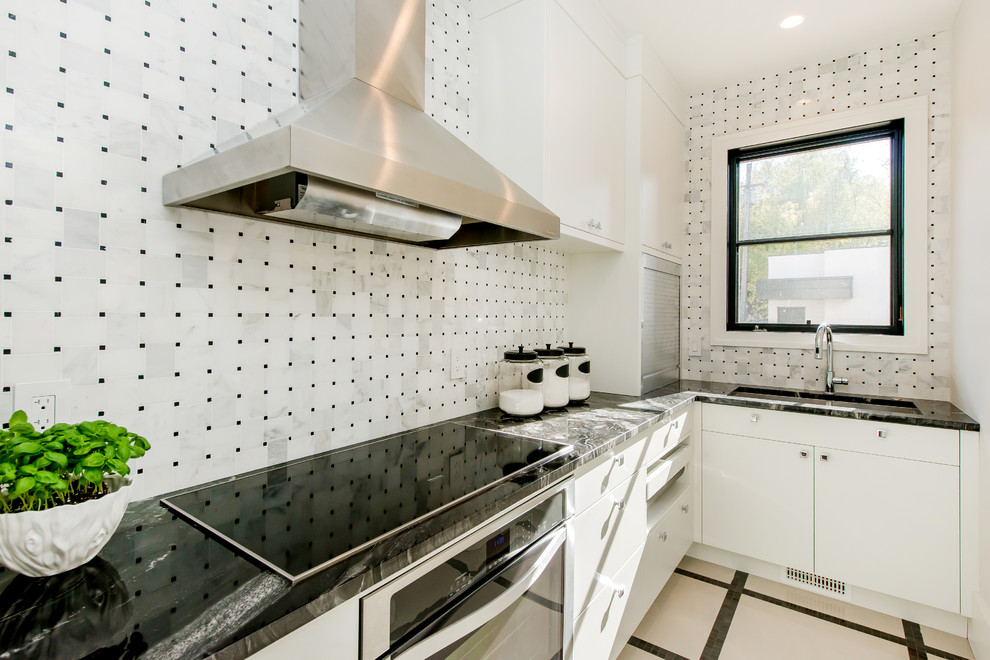 Inspiration for a large transitional l-shaped ceramic tile kitchen pantry remodel in Calgary with a double-bowl sink, flat-panel cabinets, granite countertops, white backsplash, paneled appliances, an island and stone tile backsplash