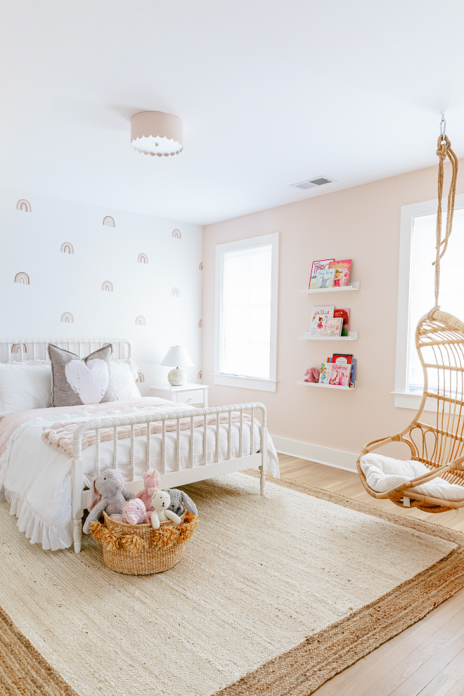 Large beach style light wood floor and brown floor kids' room photo in Other with white walls