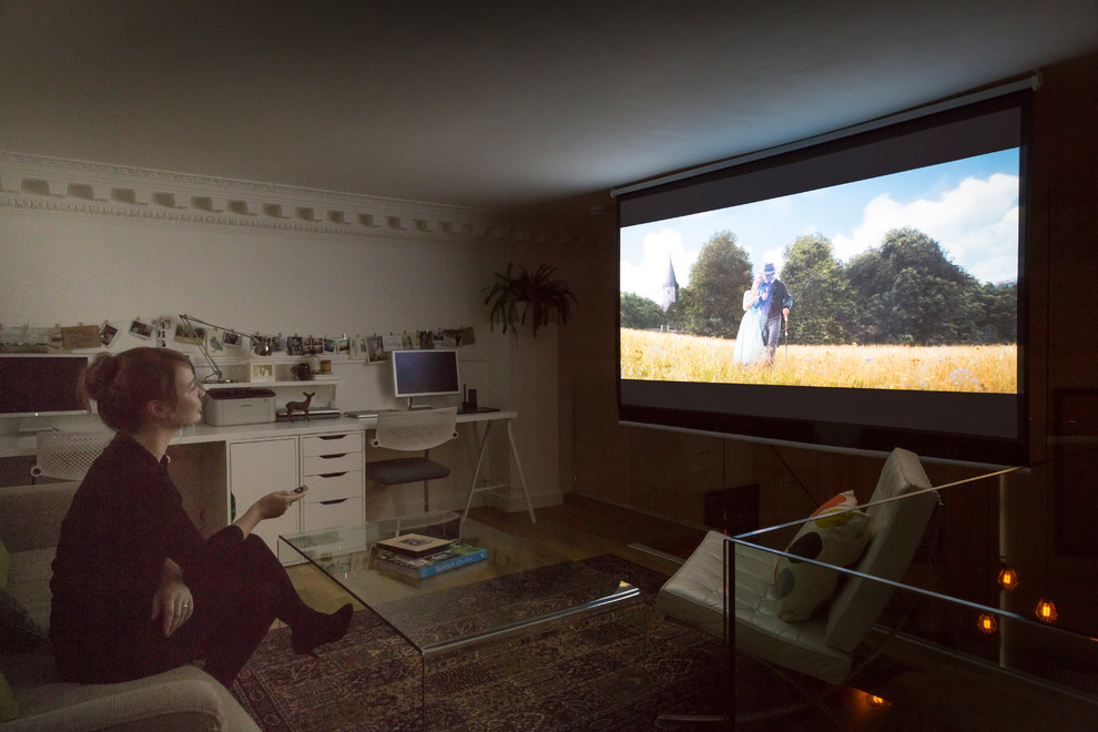 Photo of a small contemporary open plan home cinema in Edinburgh with white walls, medium hardwood flooring and a projector screen.