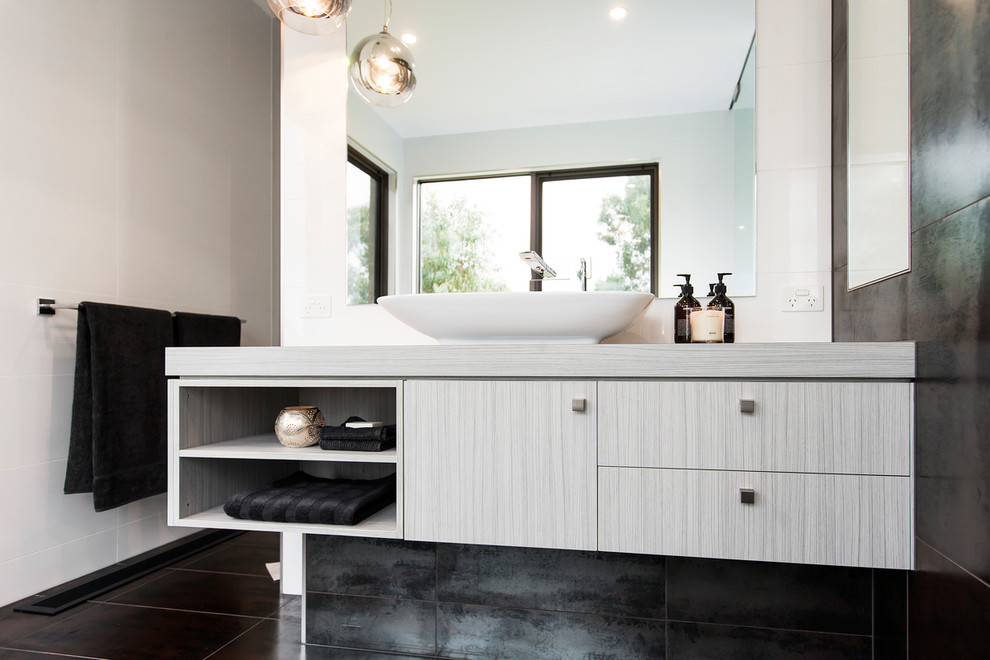 Inspiration for a large contemporary master bathroom in Toronto with a vessel sink, flat-panel cabinets, grey cabinets, laminate benchtops, multi-coloured tile, porcelain tile, white walls and porcelain floors.