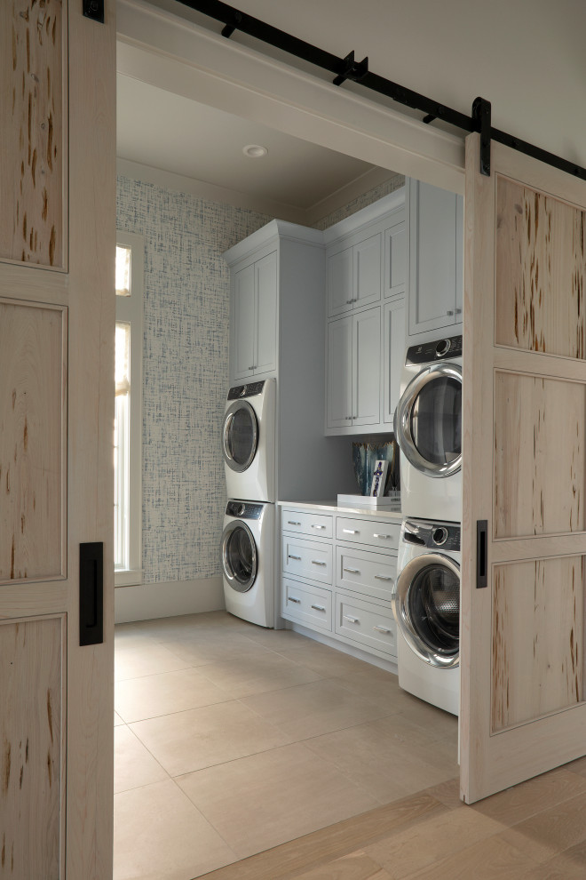 Inspiration för stora maritima vitt tvättstugor enbart för tvätt, med luckor med infälld panel, grå skåp, blå väggar, klinkergolv i keramik, en tvättpelare och beiget golv
