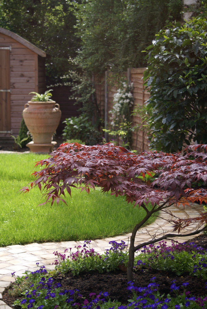 This is an example of a mid-sized country backyard partial sun garden in Cheshire.