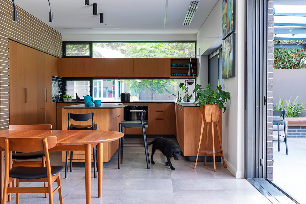 Photo of a midcentury u-shaped open plan kitchen in Perth with a double-bowl sink, flat-panel cabinets, medium wood cabinets, quartz benchtops, linoleum floors and with island.