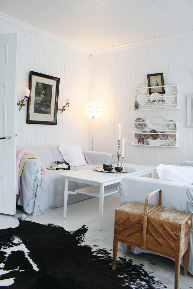 This is an example of a small scandinavian living room in Other with white walls and white floor.