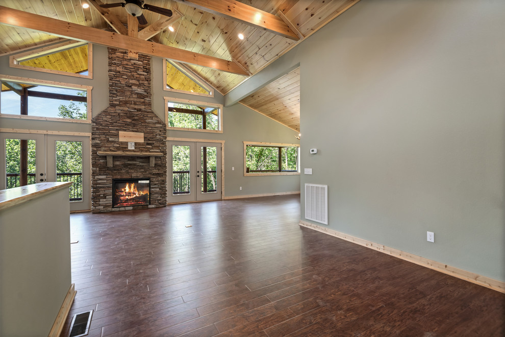 Foyer - large rustic laminate floor and brown floor foyer idea with green walls and a medium wood front door