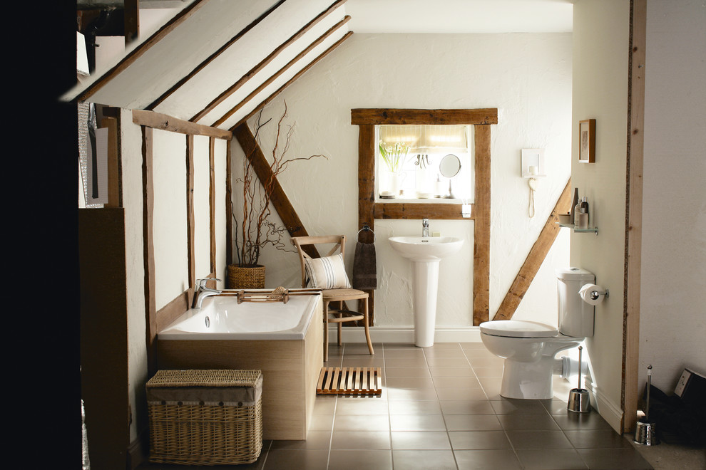 Country bathroom in West Midlands with a pedestal sink, a drop-in tub, a two-piece toilet and white walls.