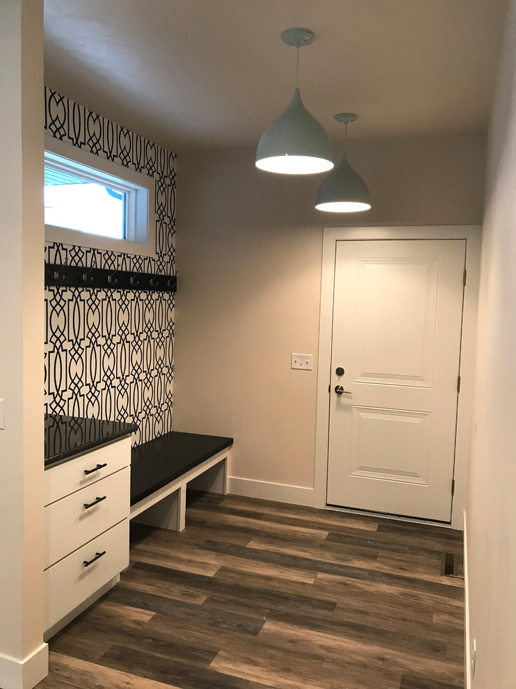 Photo of a mid-sized modern mudroom in Other with beige walls, vinyl floors, a single front door, a white front door and multi-coloured floor.