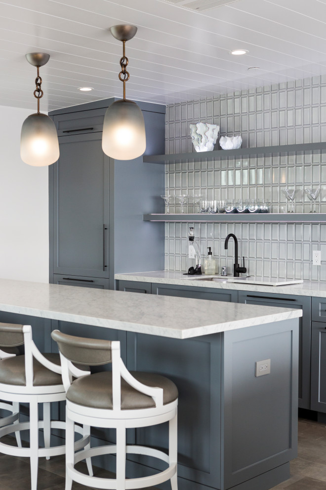 Design ideas for a mid-sized beach style galley wet bar in Los Angeles with an undermount sink, shaker cabinets, grey cabinets, marble benchtops, grey splashback, ceramic splashback, porcelain floors, grey floor and white benchtop.