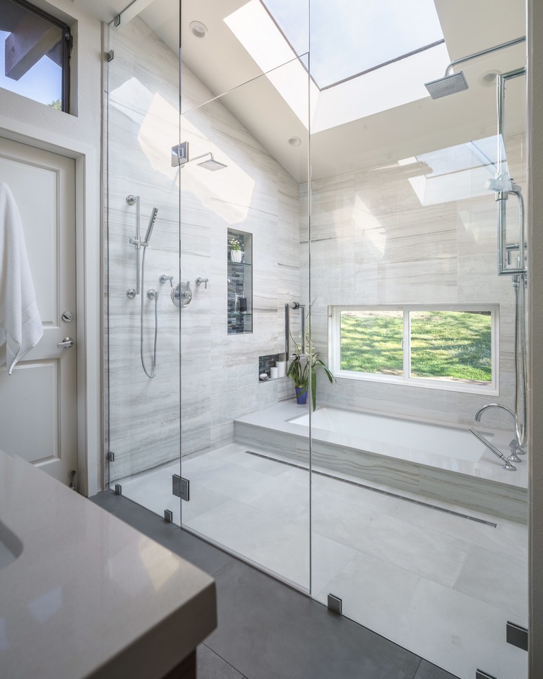 Large modern master bathroom in San Francisco with an undermount sink, medium wood cabinets, engineered quartz benchtops, an undermount tub, a curbless shower, a one-piece toilet, multi-coloured tile, porcelain tile, grey walls and porcelain floors.