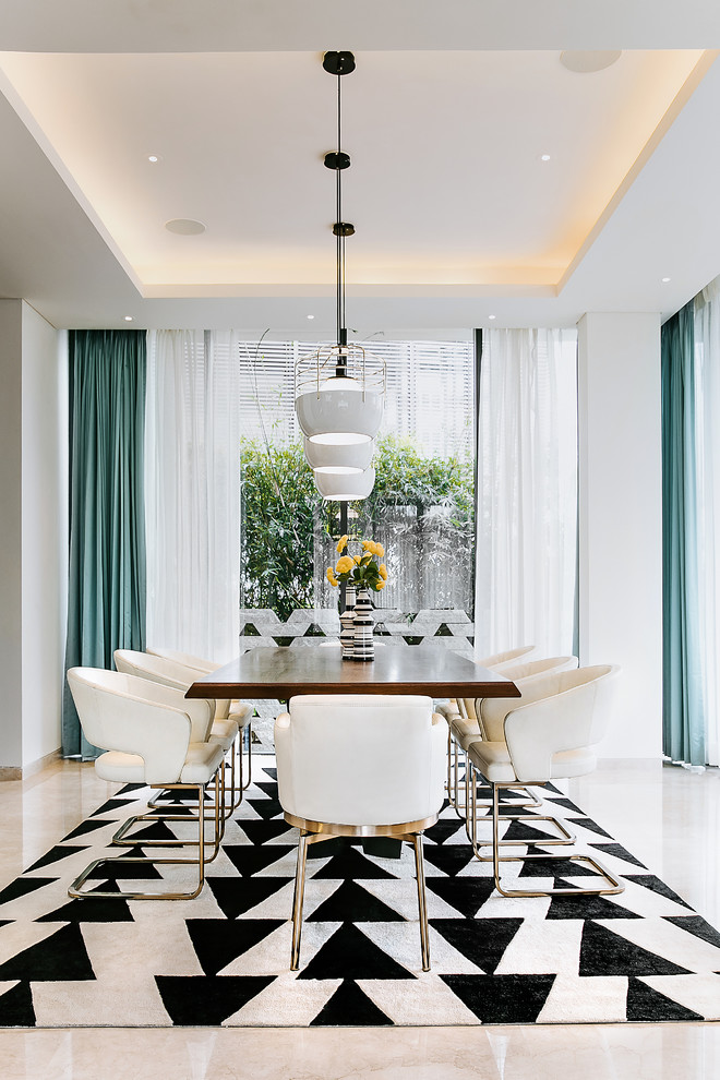 This is an example of a contemporary separate dining room in Bengaluru with white walls and beige floor.