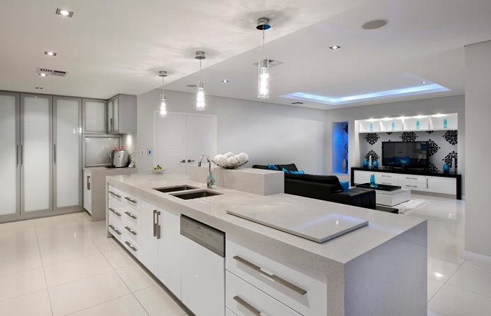 Photo of a mid-sized modern single-wall open plan kitchen in Perth with an undermount sink, flat-panel cabinets, white cabinets, granite benchtops, grey splashback, glass sheet splashback, stainless steel appliances, porcelain floors and with island.