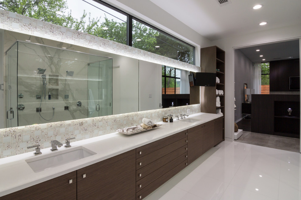 This is an example of a large contemporary master bathroom in Dallas with flat-panel cabinets, dark wood cabinets, a freestanding tub, a curbless shower, a one-piece toilet, white tile, glass tile, white walls, porcelain floors, a drop-in sink and engineered quartz benchtops.