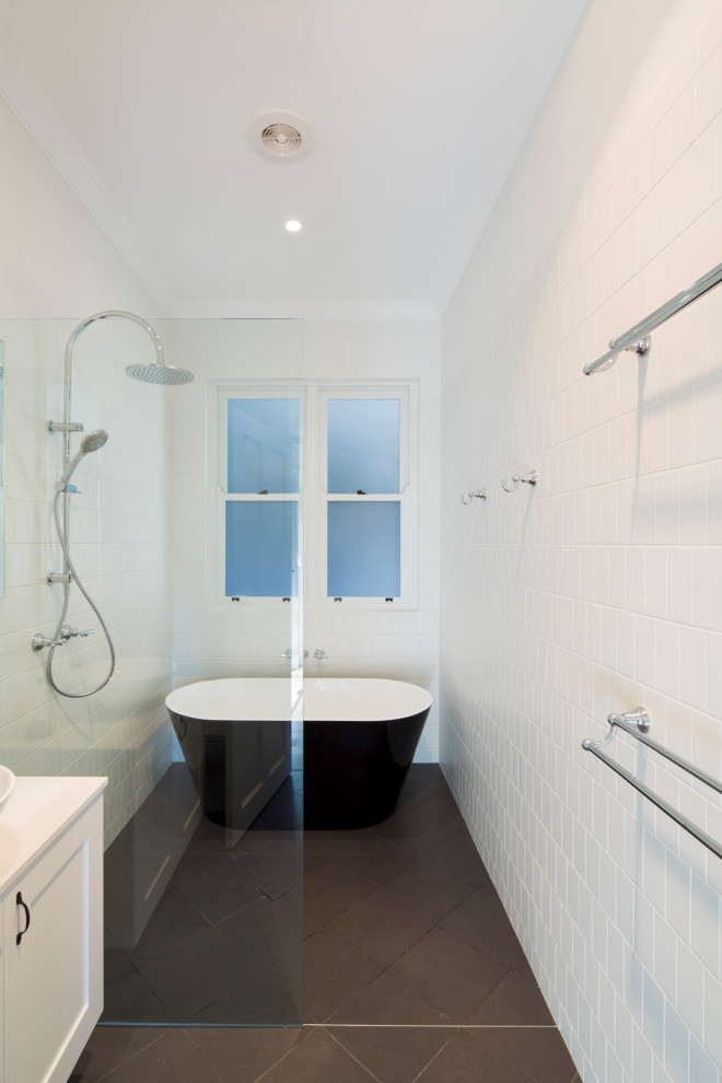 Mid-sized transitional master wet room bathroom in Sydney with shaker cabinets, white cabinets, a freestanding tub, a one-piece toilet, yellow tile, ceramic tile, white walls, ceramic floors, grey floor and an open shower.