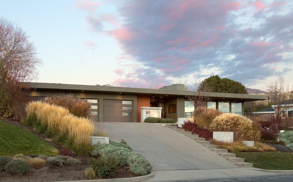 Large midcentury two-storey stucco multi-coloured house exterior in Salt Lake City with a flat roof.