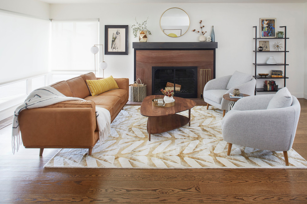 Design ideas for a large midcentury open concept living room in San Francisco with white walls, medium hardwood floors, a standard fireplace, a stone fireplace surround and brown floor.