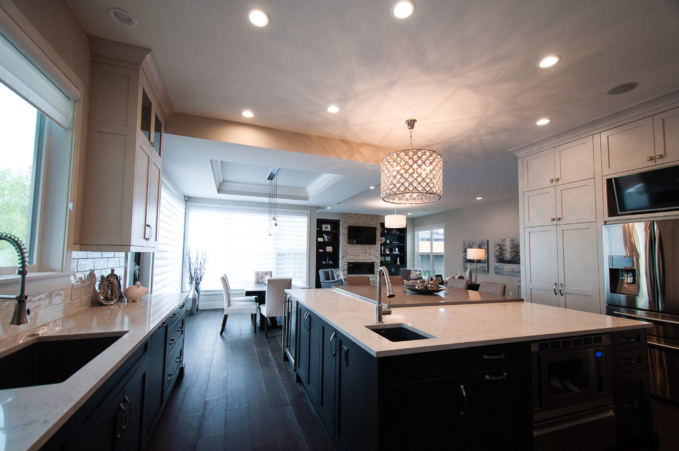 This is an example of a transitional u-shaped eat-in kitchen in Calgary with with island.