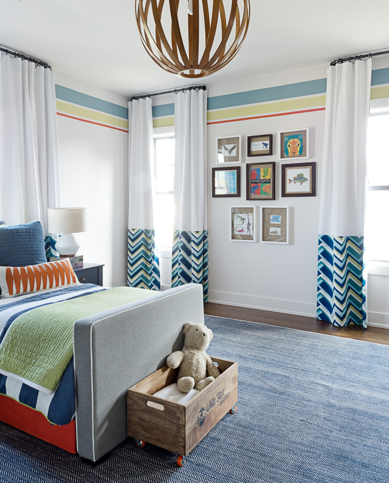 This is an example of a mid-sized transitional gender-neutral kids' bedroom for kids 4-10 years old in Other with multi-coloured walls, medium hardwood floors and brown floor.