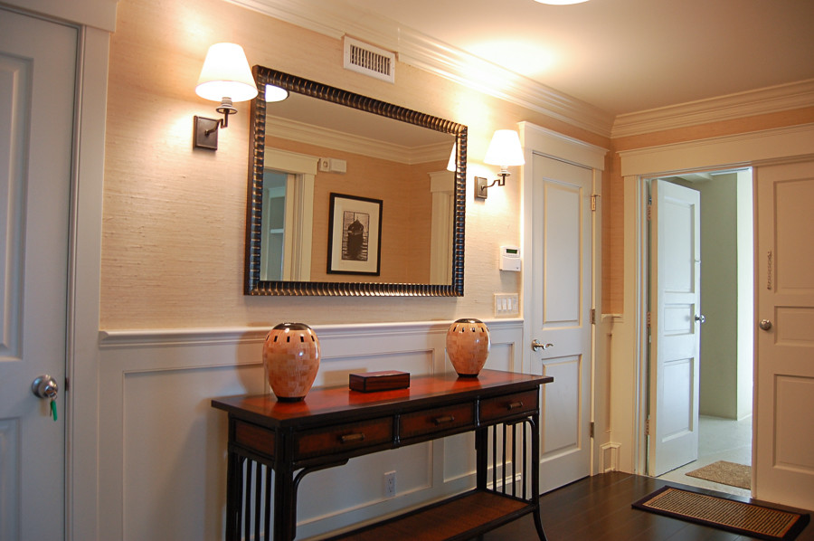 Example of a mid-sized transitional dark wood floor and brown floor hallway design in Miami with beige walls