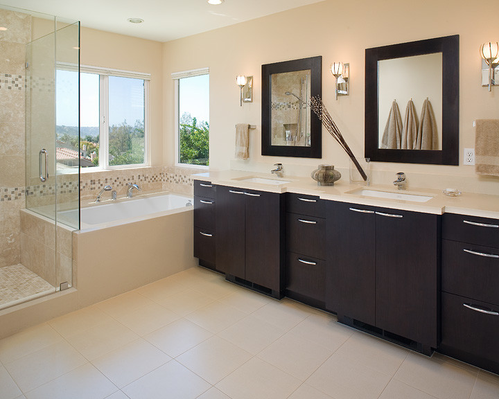 Inspiration for a modern bathroom in San Diego with an undermount sink, flat-panel cabinets, dark wood cabinets, engineered quartz benchtops, an undermount tub and beige tile.