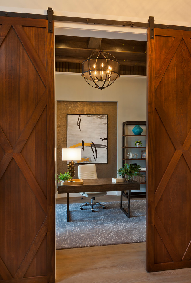 Study room - large transitional freestanding desk medium tone wood floor and brown floor study room idea in Tampa with beige walls