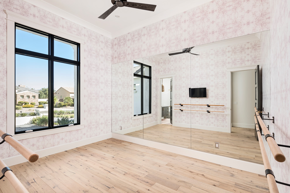 Inspiration for a transitional home gym in Phoenix with pink walls, light hardwood floors and beige floor.