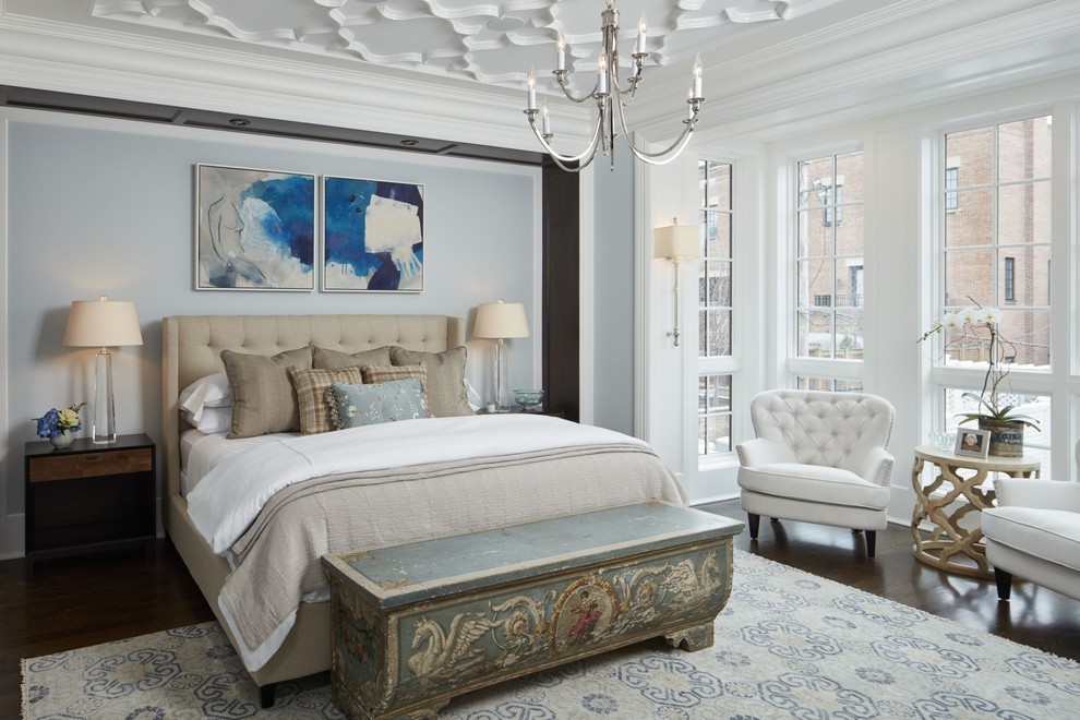 Inspiration for a large transitional master bedroom in Chicago with white walls, dark hardwood floors, a standard fireplace and a stone fireplace surround.